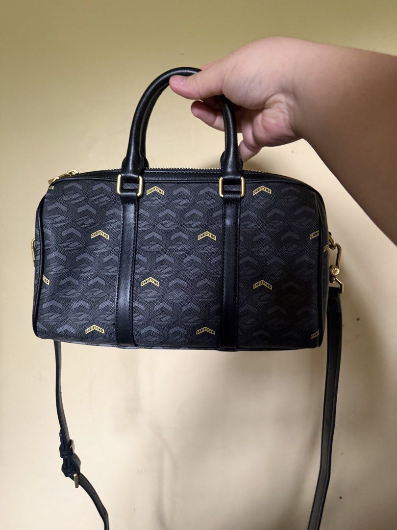 Christy Ng Enzo Mini V2 (Category: Luxury Bags & Wallets) located in Dasmarinas. Submitted by matteo_luxe (Listing ID 1455514436, Image 2). Description: - Christy Ng monogram boston bag - Color: Black with gold logo pattern - Features: Top handles and detachable shoulder strap - Hardware: Gold - Interior: One zip pocket - Includes: Dust bag - Ideal for: Everyday use No issue Authentic From Orange App, Christy Ng Official Store Rfs: Impulse Buy 1 