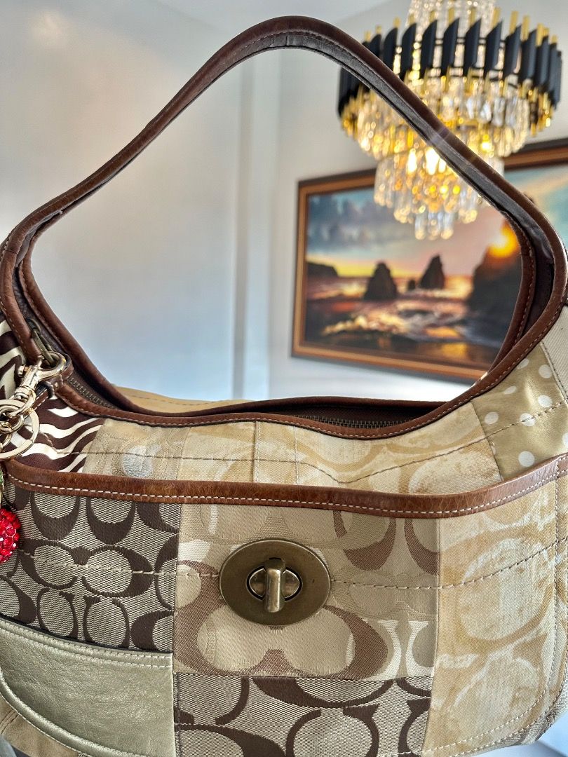 Coach Ergo Patchwork (Category: Shoulder Bags) located in Dagupan City. Submitted by emmanreyes (Listing ID 1455532126, Image 3). Description: - Brand: Coach - Model: Ergo Patchwork Hobo Bag - Design: Unique patchwork featuring Coach monogram, zebra print, and neutral tones - Material: Canvas with leather trim and strap - Features: Spacious main compartment, interior pockets, turn-lock closure, decorative charm - Style: Versatile, statement piece