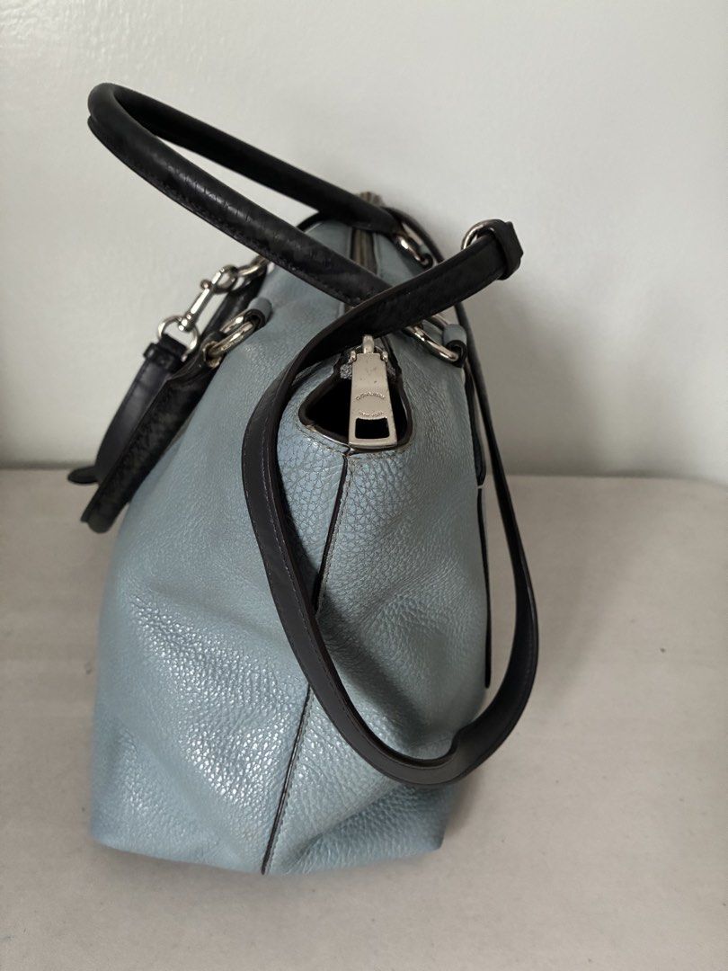Coach Light Blue Leather Satchel Handbag (Category: Luxury Bags & Wallets) located in Manila. Submitted by snappyaura (Listing ID 1455624713, Image 2). Description: - Coach light blue pebbled leather satchel bag - Black leather top handles - Detachable shoulder strap - Silver hardware - Front slip pocket - Zip-top closure - Spacious interior - Minor marks on front (please check photos) Price negotiable.