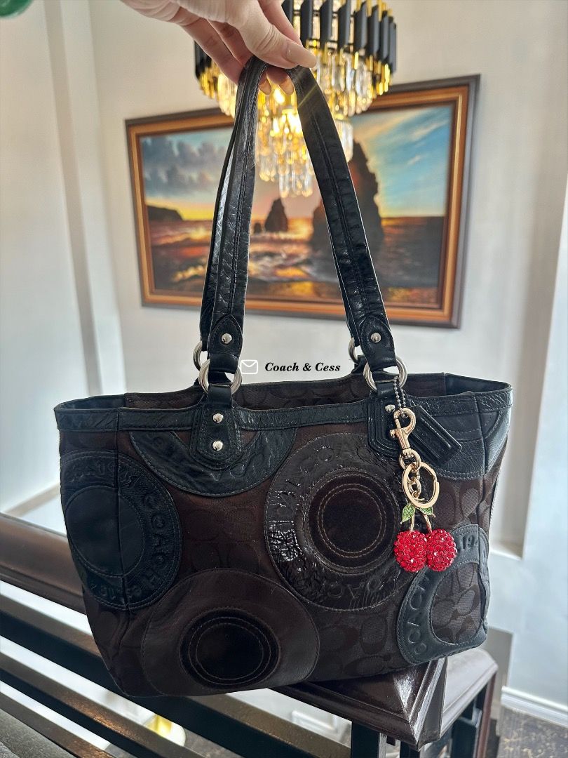 Coach Patchwork Choco Brown (Category: Shoulder Bags) located in Dagupan City. Submitted by emmanreyes (Listing ID 1455532410, Image 1). Description: - Authentic Coach tote bag - Signature monogram pattern - Leather and suede patchwork details - Adorable cherry charm included - Secure zipper closure - Durable black leather handles - Ideal for everyday use.