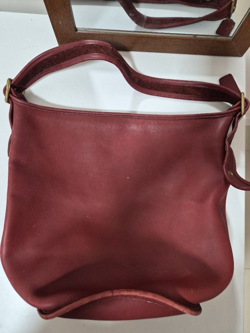 Coach Red Leather Duffle Sac XL (Category: Luxury Bags & Wallets) located in Muntinlupa City. Submitted by hcasi (Listing ID 1455512009, Image 1). Description: - Vintage cherry red leather Coach bucket bag - Classic adjustable strap - Genuine brass hardware - Signs of wear on leather and bottom edge (consistent with age) - Clean interior - Made in USA - Serial number visible in photos.