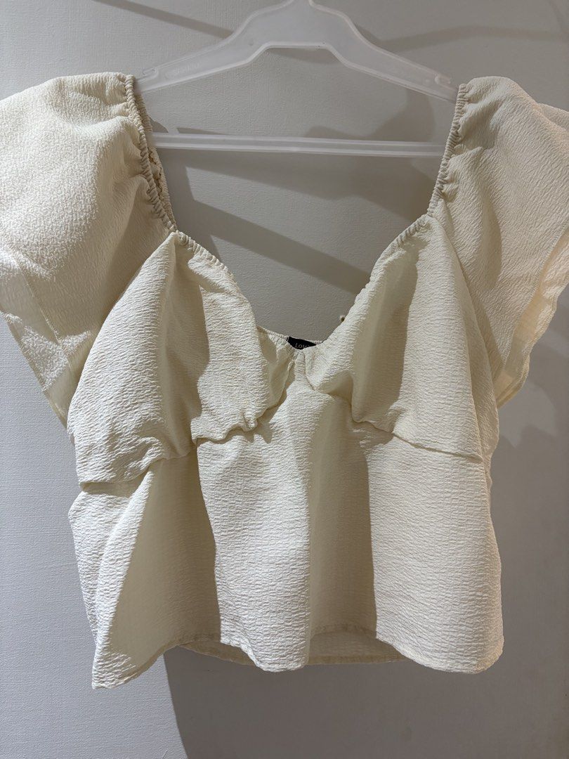 Cream Puff Sleeve Cinched Waist Top (Category: Blouses) located in Manila. Submitted by dleih (Listing ID 1455626442, Image 2). Description: - Cream colored top - Puff sleeves - Sweetheart neckline with ruching - Elasticated waist for a flattering peplum silhouette - Textured fabric - Perfect for dressing up or down.