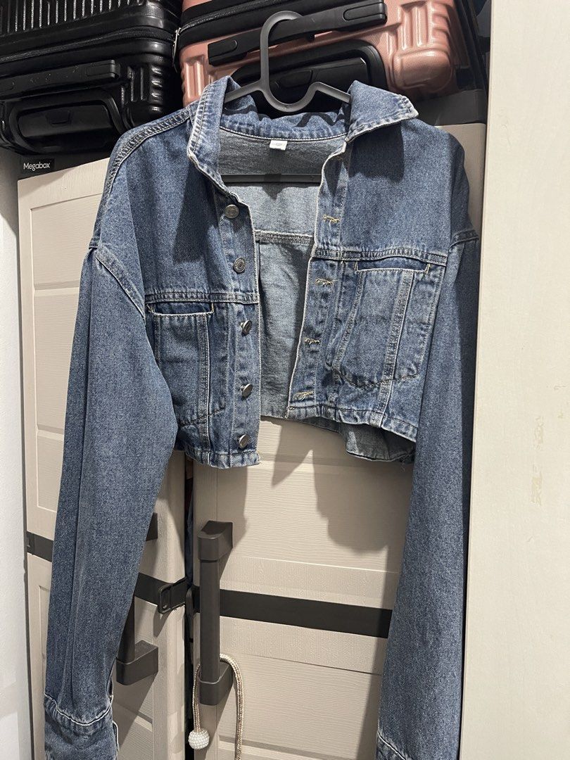 Cropped Denim Jacket (Category: Coats, Jackets and Outerwear) located in Manila. Submitted by ttbbkk (Listing ID 1455600499, Image 2). Description: - Classic blue denim jacket - Cropped style - Button-up front - Two chest pockets with button closures - Long sleeves with button cuffs - Pairs perfectly with high-waisted bottoms - A versatile wardrobe essential.