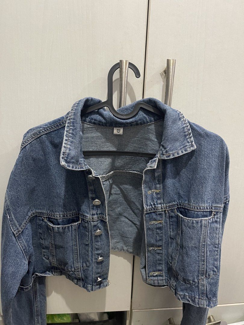 Cropped Denim Jacket (Category: Coats, Jackets and Outerwear) located in Manila. Submitted by ttbbkk (Listing ID 1455600499, Image 1). Description: - Classic blue denim jacket - Cropped style - Button-up front - Two chest pockets with button closures - Long sleeves with button cuffs - Pairs perfectly with high-waisted bottoms - A versatile wardrobe essential.