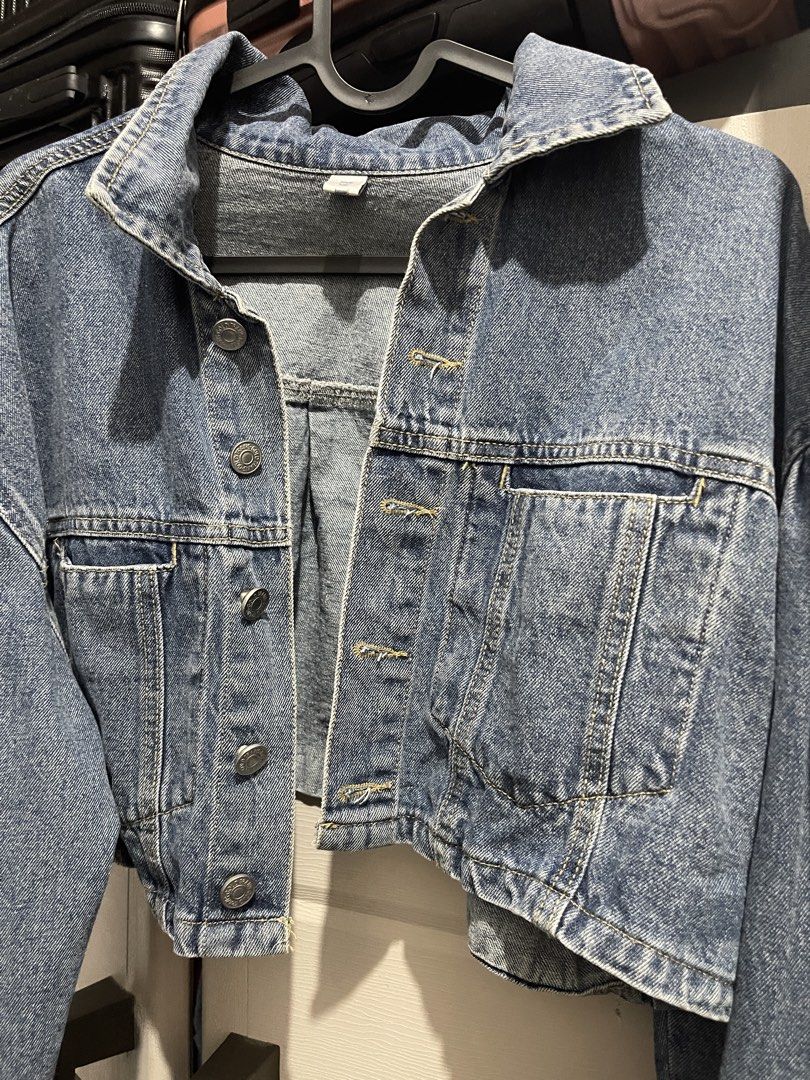 Cropped Denim Jacket (Category: Coats, Jackets and Outerwear) located in Manila. Submitted by ttbbkk (Listing ID 1455600499, Image 3). Description: - Classic blue denim jacket - Cropped style - Button-up front - Two chest pockets with button closures - Long sleeves with button cuffs - Pairs perfectly with high-waisted bottoms - A versatile wardrobe essential.