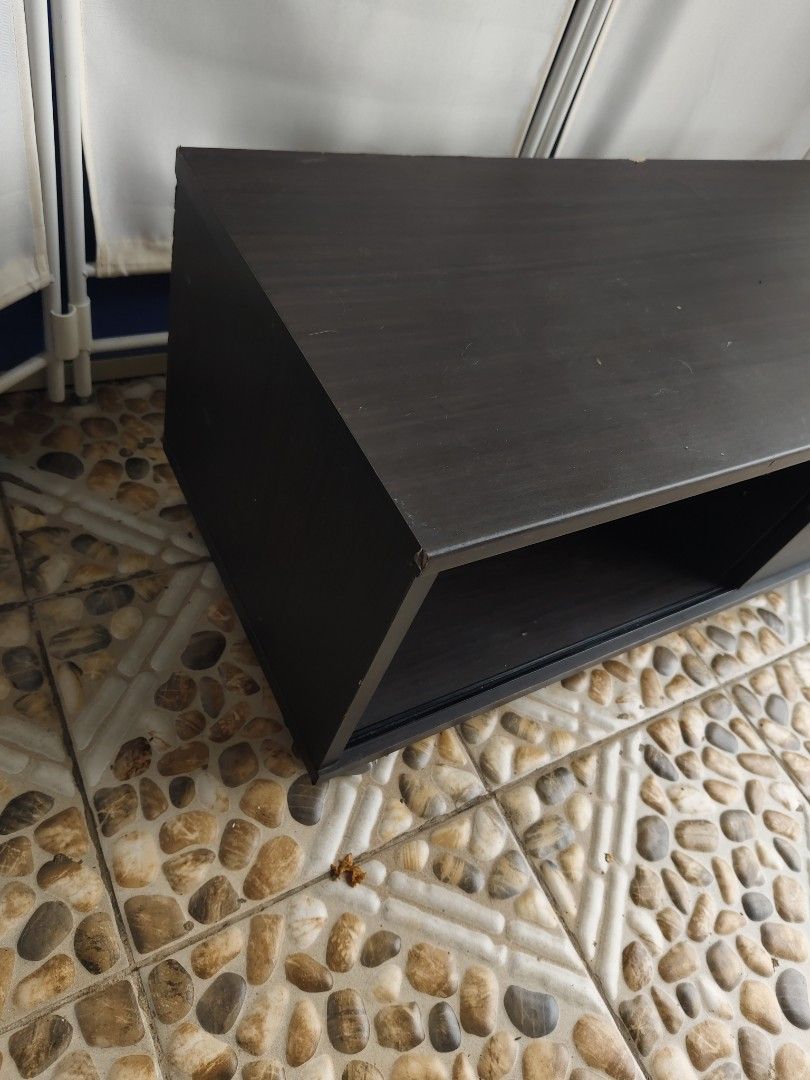 Dark Brown TV Stand with Storage and Wheels (Category: TV Consoles) located in Manila. Submitted by rapidokasm88190 (Listing ID 1455519842, Image 3). Description: - Dark brown TV stand - Features an open shelf on the left - Cabinet with a sliding door and handle on the right - Equipped with wheels for easy movement - Ideal for storing media devices and other items - Simple design complements most living room aesthetics.