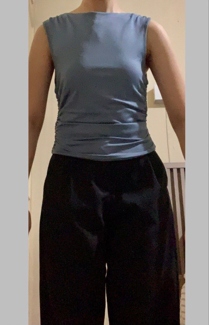 Dark Powder Blue Roushed Sleeveless Top (Category: Sleeveless) located in Paranaque City. Submitted by JarlemsApparel (Listing ID 1455621561, Image 3). Description: - Color: Dark Powder Blue/ Dusty Blue - nice quality fabric - a few stains (able to come off after laundry) - better for M body frames (hugs the body, but the roushing sinches the waist a bit, snatched!) Model: - 5’2 - S-M body frame.