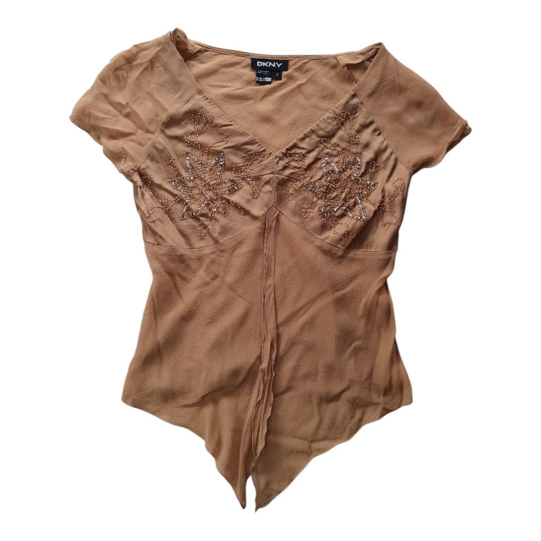 DKNY Vintage brown cap-sleeve silk top (Category: Blouses) located in Santa Cruz. Submitted by oddpenguin-4575 (Listing ID 1455645009, Image 1). Description: 📌.....P L E A S E R E A D..... 📌measurement:Laid flat Sh-18"/Sleeve-7"/Chest-15.5"/Lenght-26"/armhole-5.5"/armpit-2.5" size: fit to Small 📌Brand: DKNY 📌color-9/10 📌This vintage DKNY brown cap-sleeve top features delicate beaded floral embroidery and a dramatic asymmetric pointed hem. 📌