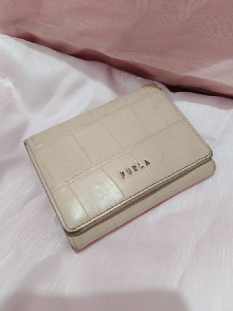 Furla Pink Croc Embossed Leather Trifold Wallet (Category: Wallets & Card holders) located in Valenzuela. Submitted by relchris22 (Listing ID 1455568949, Image 1). Description: - Furla wallet - Lovely pale pink color - Chic croc embossed texture - Convenient tri-fold design - Secure snap closure - Multiple card slots and clear ID window - Ample space for essentials - Shows some signs of wear on edges/corners, but plenty of life left.