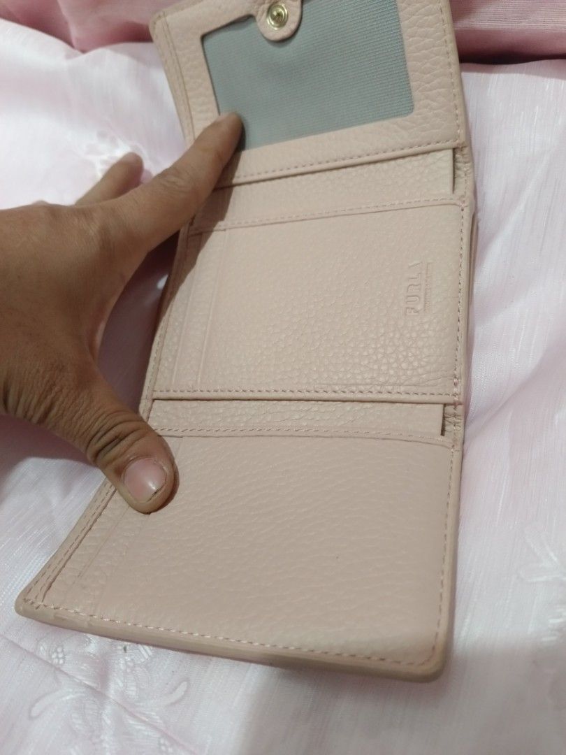 Furla Pink Croc Embossed Leather Trifold Wallet (Category: Wallets & Card holders) located in Valenzuela. Submitted by relchris22 (Listing ID 1455568949, Image 2). Description: - Furla wallet - Lovely pale pink color - Chic croc embossed texture - Convenient tri-fold design - Secure snap closure - Multiple card slots and clear ID window - Ample space for essentials - Shows some signs of wear on edges/corners, but plenty of life left.