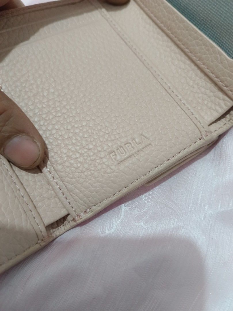 Furla Pink Croc Embossed Leather Trifold Wallet (Category: Wallets & Card holders) located in Valenzuela. Submitted by relchris22 (Listing ID 1455568949, Image 3). Description: - Furla wallet - Lovely pale pink color - Chic croc embossed texture - Convenient tri-fold design - Secure snap closure - Multiple card slots and clear ID window - Ample space for essentials - Shows some signs of wear on edges/corners, but plenty of life left.