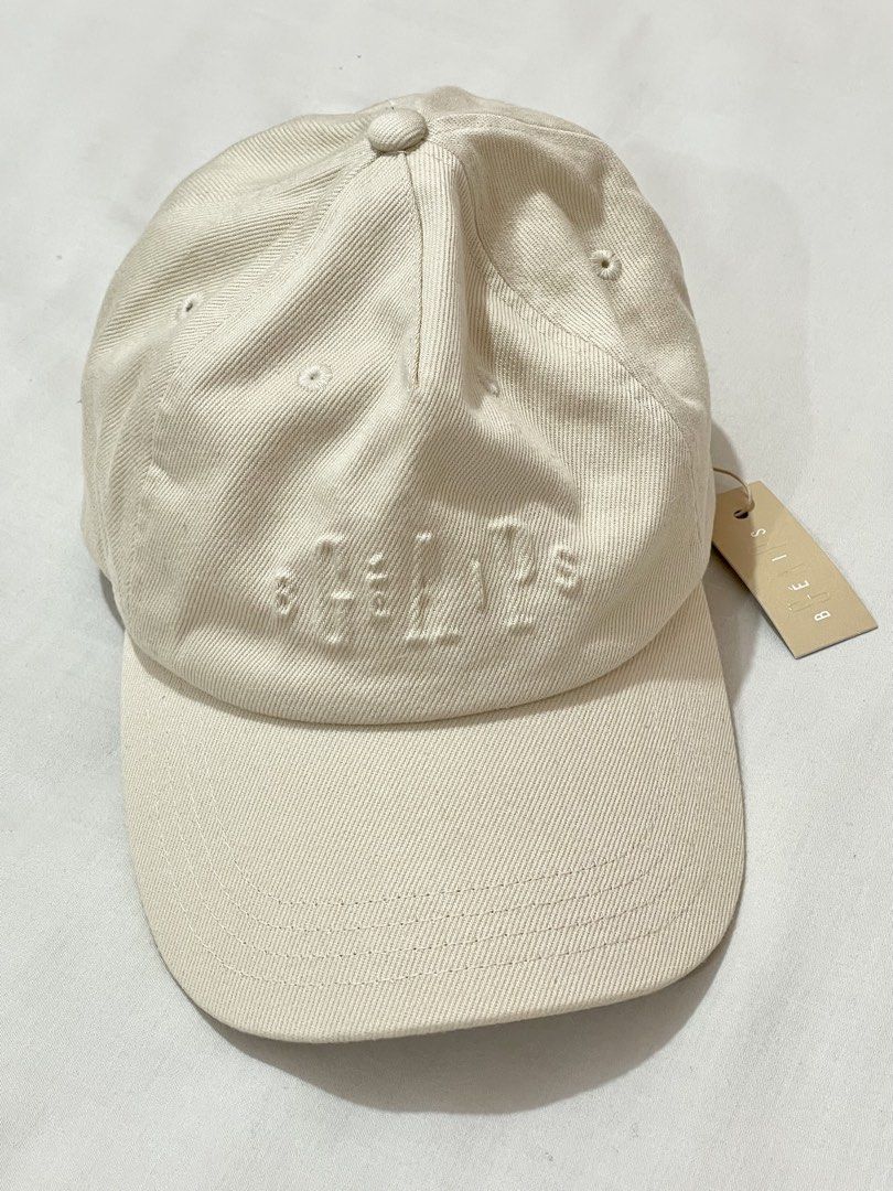Gap x Béis Logo Baseball Hat in Beige (Category: Other Accessories) located in San Jose del Monte. Submitted by declothering_ph (Listing ID 1455543666, Image 1). Description: - Brand: Gapx Béis - Color: Beige Cream - Style: Baseball Cap - Features: Embroidered logo on front, adjustable strap at back - Condition: Brand new with original tags - Original Price: $34 (Php 2000).