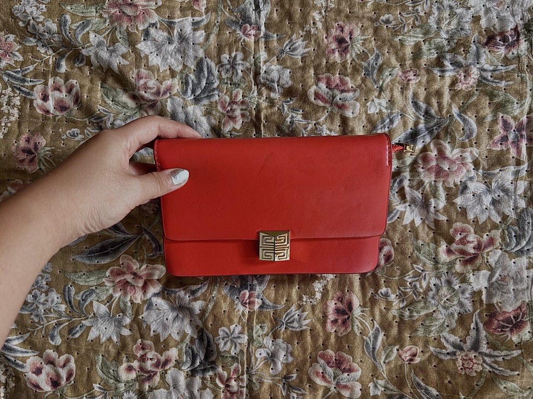 Red Leather Clutch Bag with Gold Clasp (Category: Luxury Bags & Wallets) located in Manila. Submitted by urechicthrftmnl (Listing ID 1455608530, Image 3). Description: - Genuine Givenchy red leather clutch - Features the iconic gold clasp closure - Compact size, ideal for evening events or as a statement accessory - Additional gold zipper detail at the top - Smooth, high-quality leather feel - [Insert measurement here if known].