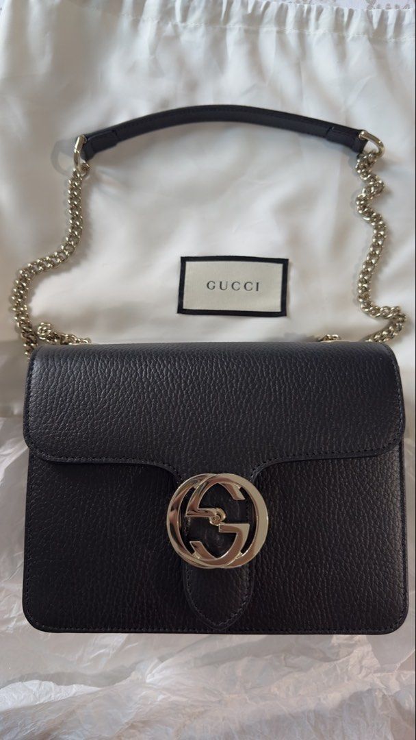 Gucci Black Leather Interlocking G Chain Shoulder Bag (Category: Luxury Bags & Wallets) located in Makati City. Submitted by mitch_jlc (Listing ID 1455612740, Image 2). Description: - Authentic Gucci black leather shoulder bag - Iconic silver interlocking G logo - Comes with silver chain strap and leather shoulder strap - Beige fabric interior lining - Made in Italy - Dust bag included - G logo is PPF by Olympus of R33 cars Rare and discontinued 