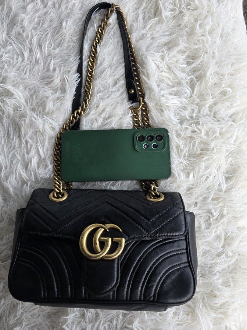 Gucci Marmont Black Leather Chain Shoulder Bag (Category: Luxury Bags & Wallets) located in Lemery. Submitted by venus23 (Listing ID 1455609939, Image 2). Description: - Black Leather Gucci Marmont Bag - Iconic GG Logo and Chevron Quilting - Gold-Tone Chain Strap - Shows some signs of wear on hardware and leather edges (adds character!) - Perfect size for your daily essentials - Versatile for both day and night use.