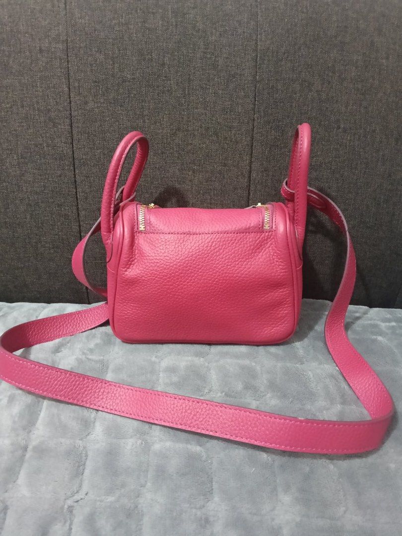 Hermes Lindy Bag Pink Leather 18cm (Category: Luxury Bags & Wallets) located in Cebu City. Submitted by latendacebubuys (Listing ID 1455553718, Image 2). Description: - Stylish pink leather handbag - Elegant gold hardware accents - Versatile carrying options: shoulder strap and top handles - Secure zipper closure - Decorative lock detail on the front flap - Note: Some creasing on the leather exterior - Interior is clean and well-maintained.