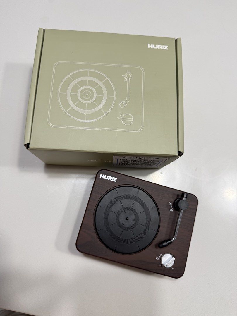 HURIZ Mini Turntable Record Player (Category: Other Audio Equipment) located in Quezon City. Submitted by miccachic (Listing ID 1455559177, Image 2). Description: - HURIZ mini turntable - Stylish wood grain finish - Easy ON/OFF switch - Adjustable volume control - Comes with original box - Ideal for playing records.