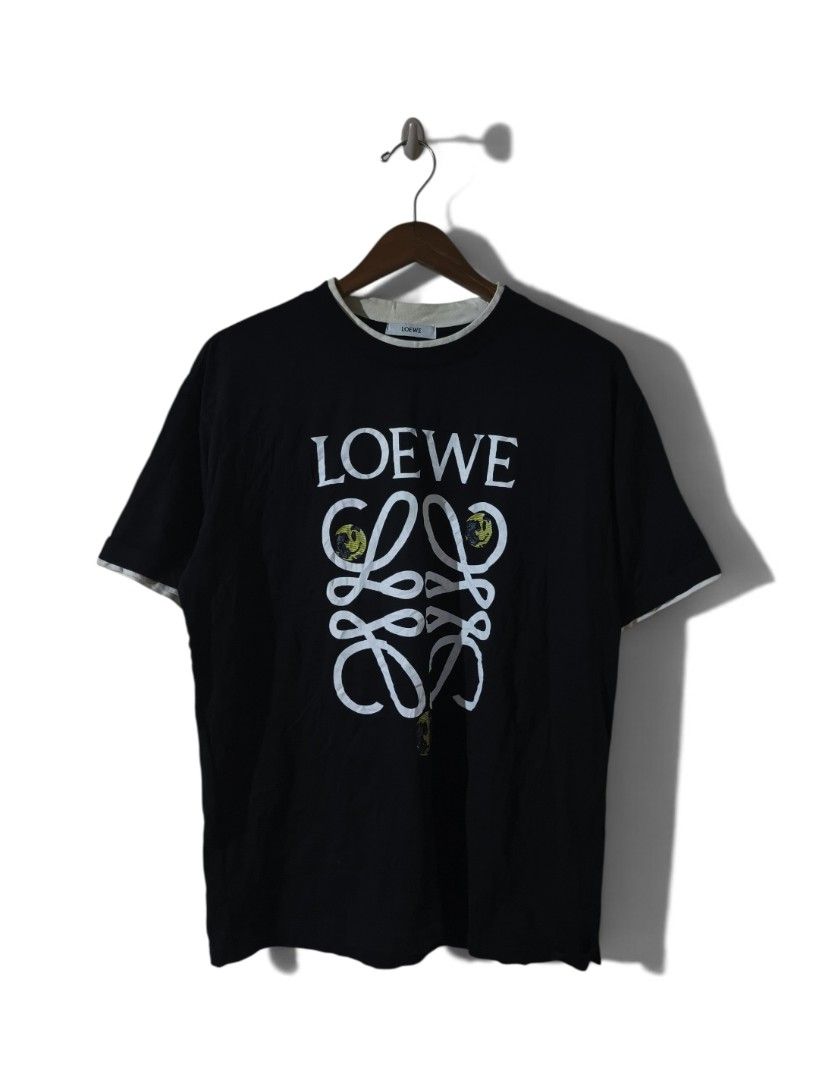Loewe Black T-Shirt with Anagram Logo (Category: Shirts) located in Talisay. Submitted by rubiobryle20102 (Listing ID 1455651920, Image 1). Description: - Loewe black t-shirt - Size: L - Iconic Anagram logo on the front - Small smiley face graphic with Loewe logo on the back - Double-layered collar detail - 100% premium cotton Price: 780 Free shipping📥.