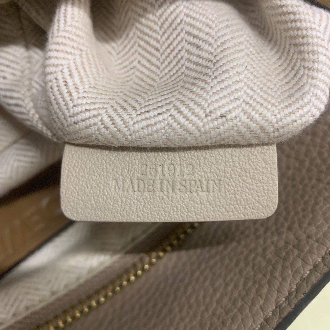 Loewe Puzzle Bag Taupe Leather (Category: Luxury Bags & Wallets) located in Antipolo. Submitted by RAREFINDS (Listing ID 1455622095, Image 3). Description: - Loewe Puzzle bag - Color: Taupe - Material: Pebble grain leather - Hardware: Gold tone - Closure: Zipper - Features: Classic geometric design, comfortable top handle - Interior: Loewe logo tag, 'Made in Spain' stamp - Ideal for: Everyday use.