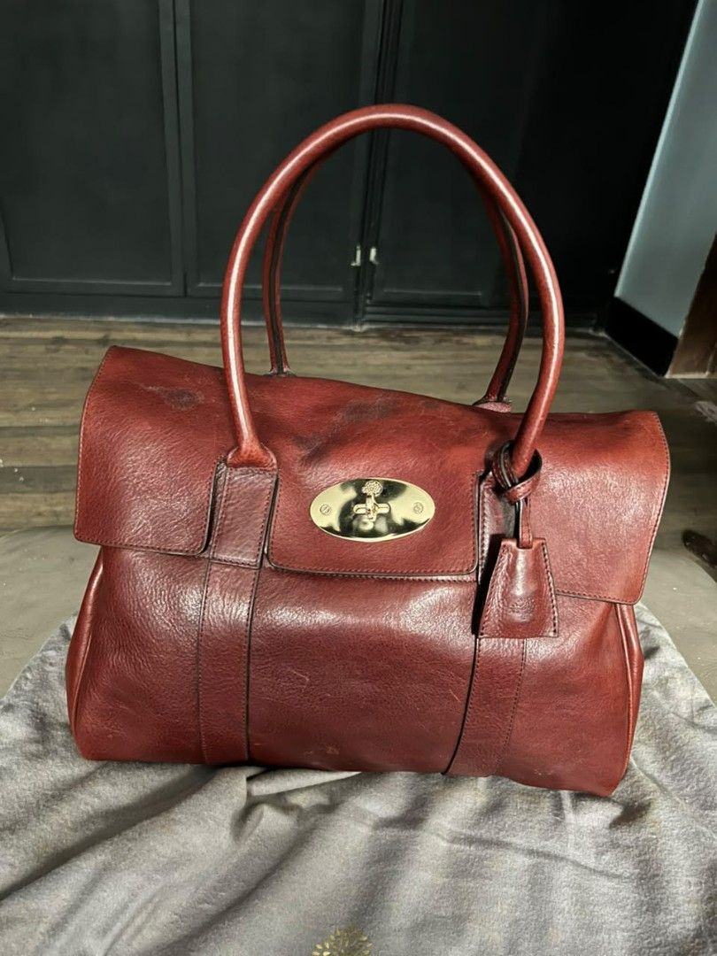 Mulberry Bayswater Red Leather Handbag (Category: Luxury Bags & Wallets) located in Quezon City. Submitted by thriftshopmar (Listing ID 1455515152, Image 1). Description: - Classic Mulberry Bayswater bag - Made from red leather - Features iconic postman's lock closure - Top handles for carrying - Comes with Mulberry dust bag - A timeless piece for your collection.