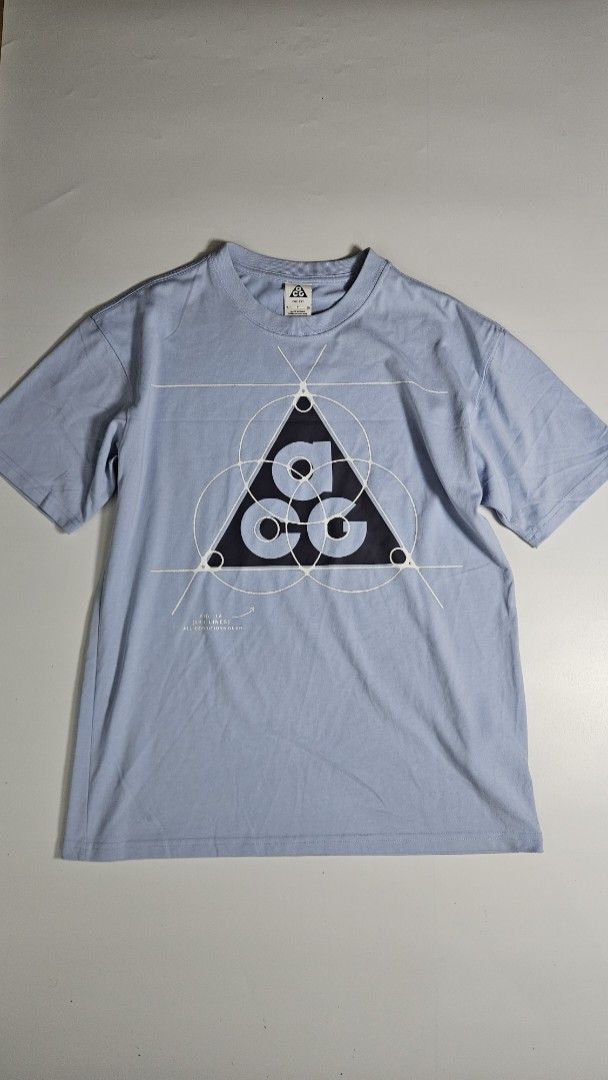 Nike ACG Leyline T-Shirt (Category: Tshirts & Polo Shirts ) located in Alfonso. Submitted by jbcamet (Listing ID 1455613264, Image 1). Description: - Light blue Nike ACG t-shirt - Features iconic ACG triangle logo graphic - Made with Dri-FIT material for comfort - Size S - Ideal for everyday wear or outdoor activities.