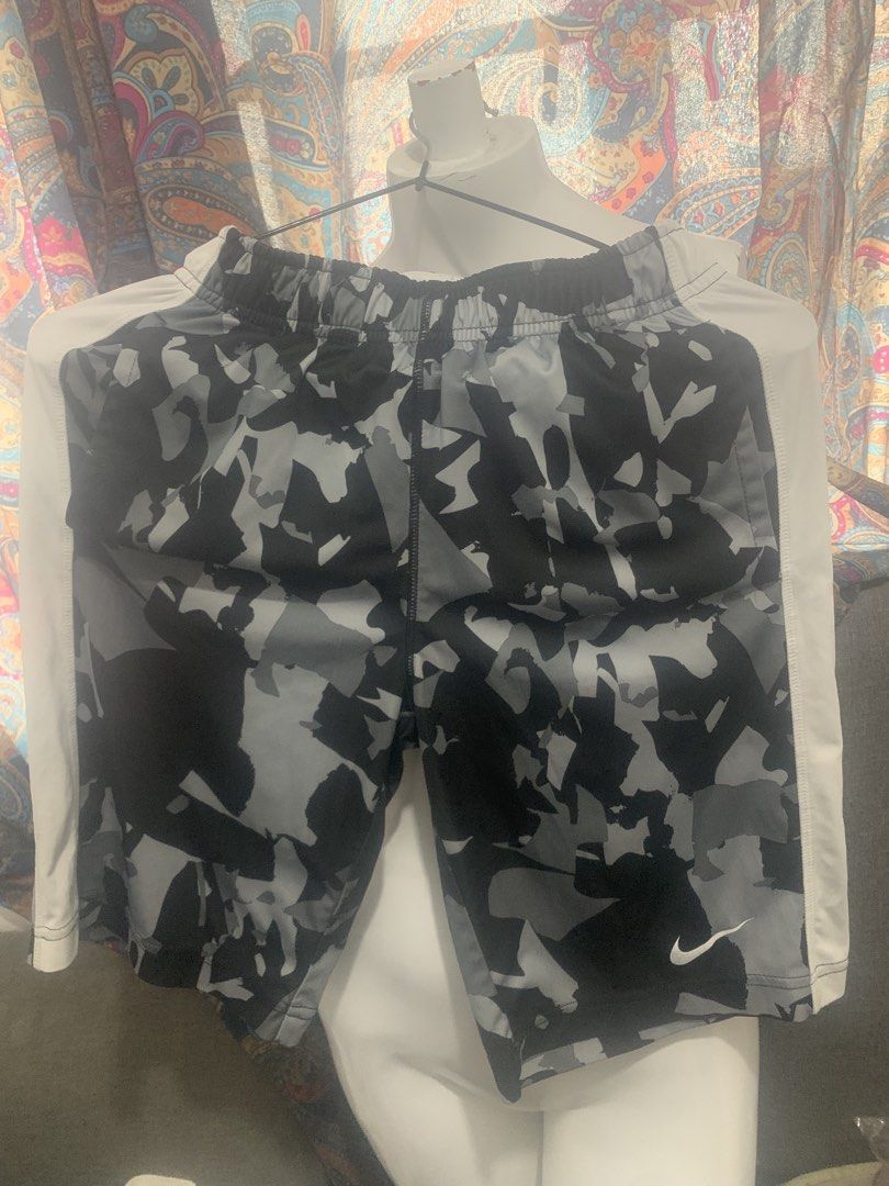 Nike Dri-Fit Camo Athletic Shorts Size S (Category: Shorts) located in Manila. Submitted by closetsunday (Listing ID 1455594584, Image 1). Description: - Nike Dri-Fit athletic shorts - Cool grey and black camouflage pattern - White side panels - Elastic waistband with drawstring - Small Nike swoosh logo on right leg - Perfect for sports or casual wear.