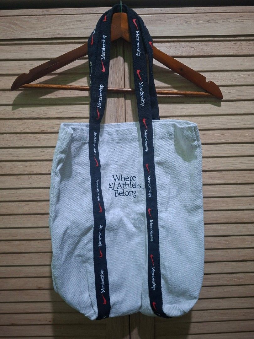 Nike Membership Tote Bag (Category: Tote Bags) located in Paranaque City. Submitted by stufflykdat (Listing ID 1455597232, Image 1). Description: - White canvas tote bag from Nike - Features the 'Where All Athletes Belong' slogan - Straps have repeated Nike logos and 'Membership' text - Ideal for everyday use or gym sessions.