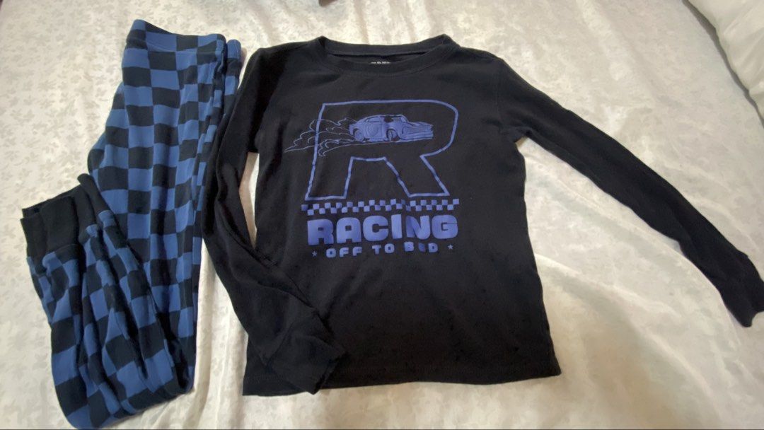 Old Navy Boys' Racing Pajama Set (Category: Babies & Kids Fashion) located in Taguig. Submitted by cosmic.jengck320 (Listing ID 1455505333, Image 1). Description: - Old Navy boys' pajama set - Black long-sleeve shirt with blue 'R' and car graphic - Shirt text: 'RACING OFF TO BED' - Blue and black checkered pajama pants - Comfy sleepwear for kids - Ideal for little racers.