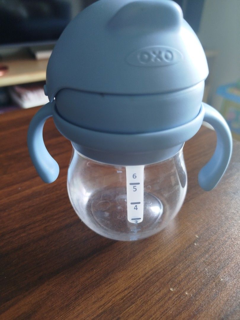 OXO Tot Straw Sippy Cup Blue (Category: Weaning & Toddler Feeding) located in Paranaque City. Submitted by kaceys_closet (Listing ID 1455553762, Image 2). Description: - Blue OXO Tot straw sippy cup - Features handles for easy grip - Measurements marked on the side - Ideal for toddlers learning to drink independently - Easy to clean and use.