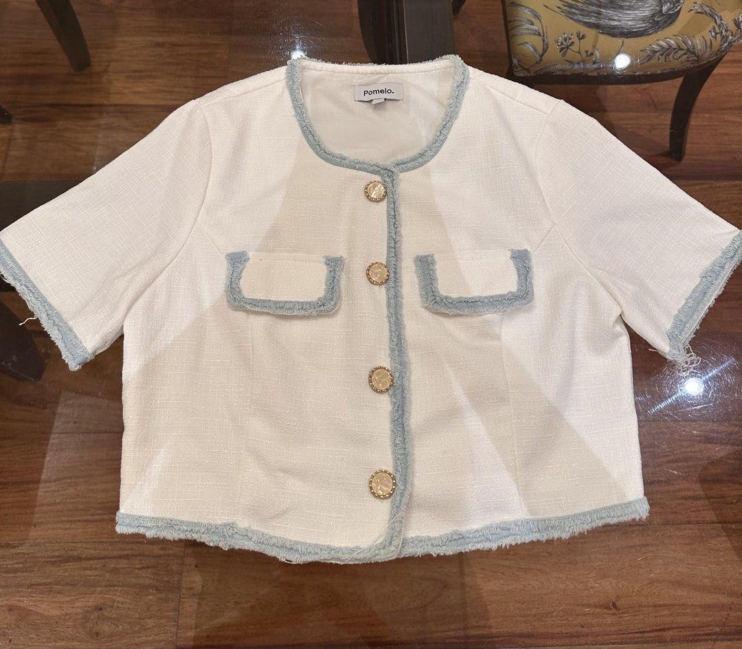 Pomelo White Tweed Cropped Jacket with Blue Trim (Category: Coats, Jackets and Outerwear) located in Manila. Submitted by natashaalex (Listing ID 1455598702, Image 1). Description: - White cropped blouse from Pomelo - Short sleeves with frayed blue trim - Gold button closures - Two chest pockets with blue trim - Frayed hem detail - Ideal for layering.