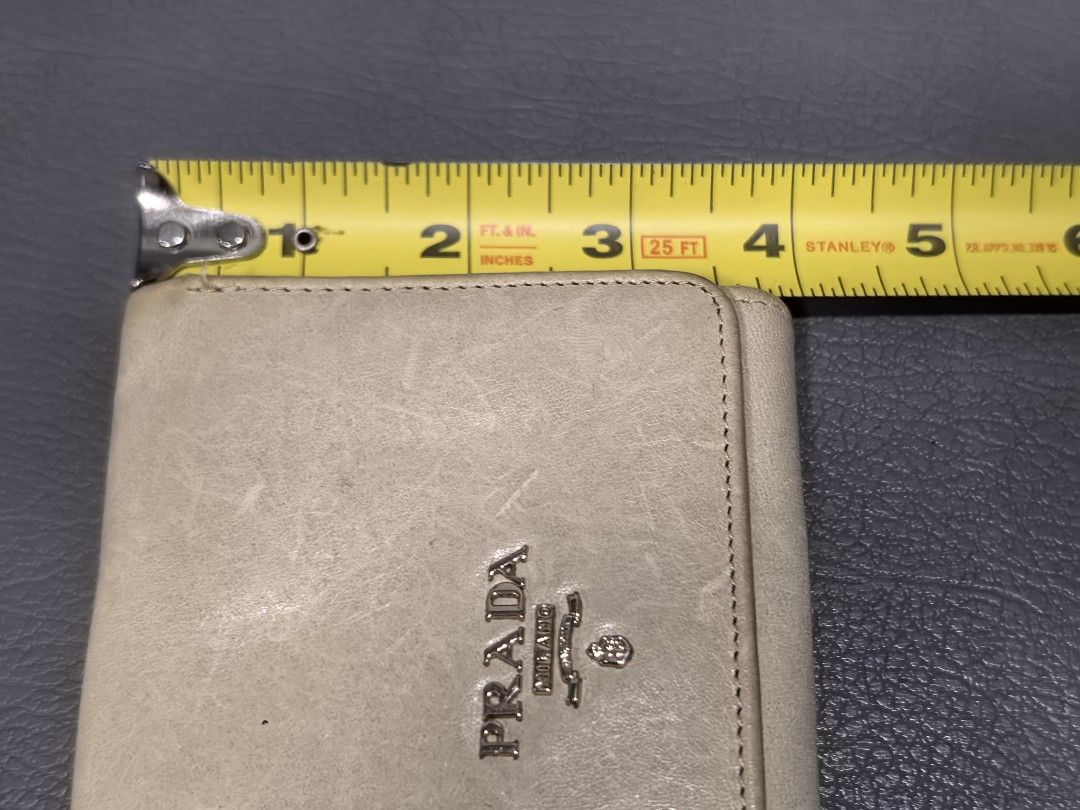 Prada Beige Leather Bi-Fold Wallet (Category: Luxury Bags & Wallets) located in Cagayan de Oro. Submitted by pootx (Listing ID 1455595251, Image 2). Description: - Authentic Prada bi-fold wallet - Color: Beige - Material: Leather - Features: Multiple card slots, coin pocket - Origin: Made in Italy.