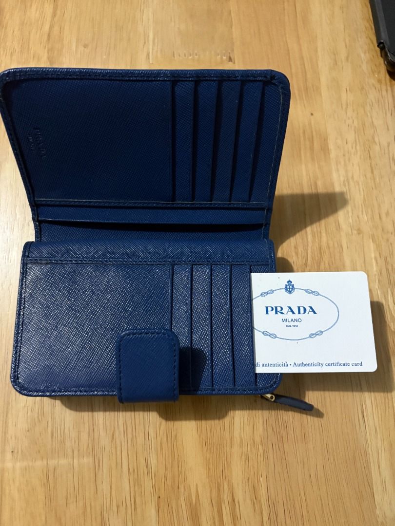 Prada Blue Saffiano Leather Wallet (Category: Luxury Bags & Wallets) located in Muntinlupa City. Submitted by rnastor (Listing ID 1455632013, Image 3). Description: Authentic blue Prada Saffiano leather wallet with card only Features card slots, zip pocket, and snap closure. Meet up can be arranged at Alabang Town Ctr or Bacoor Colisuem .