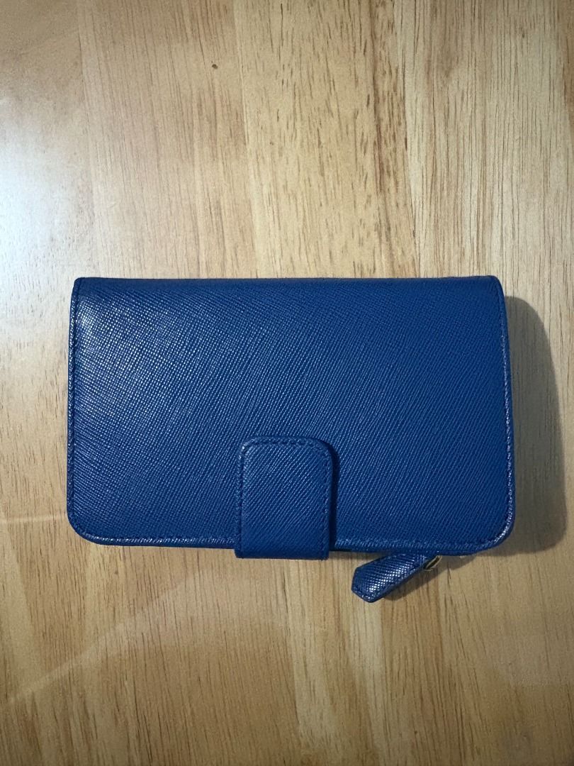 Prada Blue Saffiano Leather Wallet (Category: Luxury Bags & Wallets) located in Muntinlupa City. Submitted by rnastor (Listing ID 1455632013, Image 2). Description: Authentic blue Prada Saffiano leather wallet with card only Features card slots, zip pocket, and snap closure. Meet up can be arranged at Alabang Town Ctr or Bacoor Colisuem .