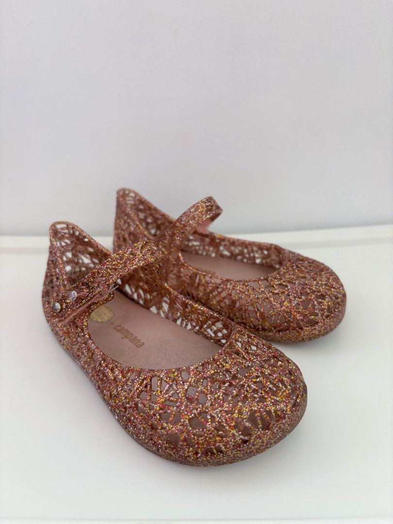 Preloved Bundle Mini Melissa Bundle US9 Jelly Shoes (Category: Babies & Kids Fashion) located in Marilao. Submitted by lmsboutique (Listing ID 1455582172, Image 3). Description: - Bundle of 2 pairs Mini Melissa jelly shoes - Pair 1: Dark glitter with black bows - Pair 2: Rose gold glitter with cutout design - Both are Mary Jane style with buckle straps - Perfect for little girls (Natatanggal na po yung black ribbon nung dollshoes dinikitan ko lan