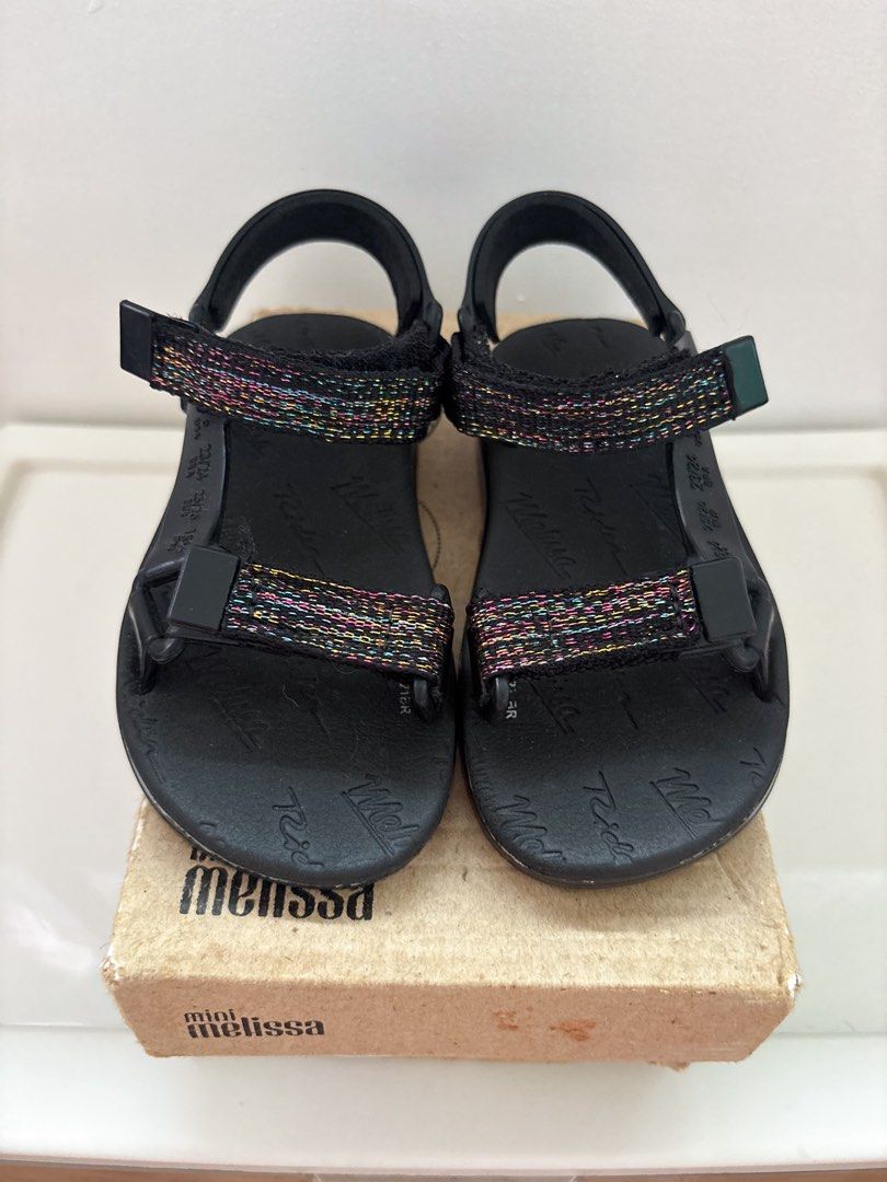 Preloved Mini Melissa Black Sandals US9 (Category: Babies & Kids Fashion) located in Marilao. Submitted by lmsboutique (Listing ID 1455589606, Image 2). Description: - Black Mini Melissa sandals - Size US 9 - Adjustable straps with colorful glitter detail - Soles feature Melissa and Rider logos - Comes with original box (medyo may yupi na po yung box and no dustbag) - may matigas na nakadikit sa outsole .