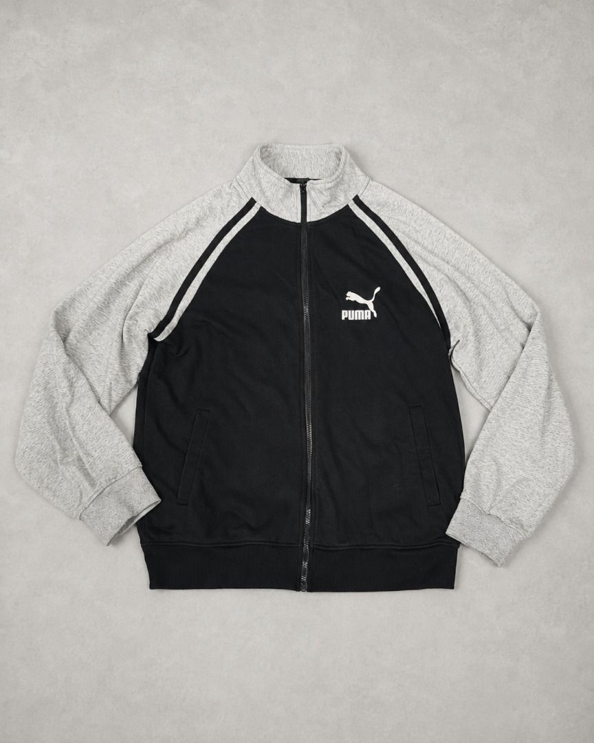 Puma Full-Zip Track Jacket (Category: Coats, Jackets and Outerwear) located in Valencia. Submitted by shopstnd (Listing ID 1455647875, Image 1). Description: Puma Full-Zip Track Jacket Clean black and heather gray colorway with classic Puma branding, contrast piping, and a large back logo. • Size: 2XL • Full-zip design • Front Puma logo • Large back Puma graphic • Ribbed cuffs & hem • Pre-owned condition • Made in China Please check all photos ca