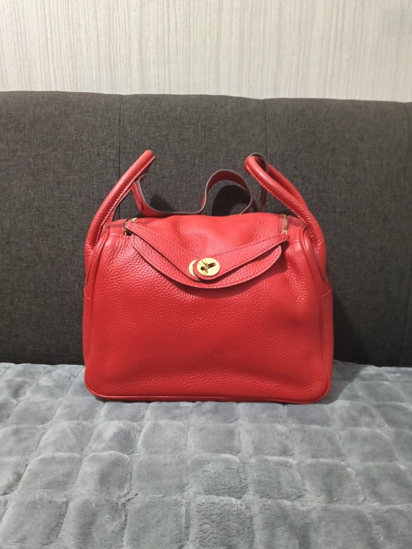 Red Leather Top Handle Bag with Gold Hardware 26cm (Category: Luxury Bags & Wallets) located in Cebu City. Submitted by latendacebubuys (Listing ID 1455553134, Image 1). Description: - Classic red leather handbag - Structured shape with secure turn-lock closure - Beautiful pebbled leather texture - Spacious interior lined in red - Elegant gold hardware details - Comfortable top handles for easy carrying.