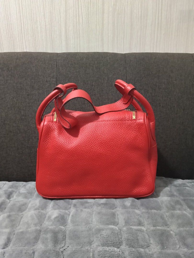 Red Leather Top Handle Bag with Gold Hardware 26cm (Category: Luxury Bags & Wallets) located in Cebu City. Submitted by latendacebubuys (Listing ID 1455553134, Image 2). Description: - Classic red leather handbag - Structured shape with secure turn-lock closure - Beautiful pebbled leather texture - Spacious interior lined in red - Elegant gold hardware details - Comfortable top handles for easy carrying.