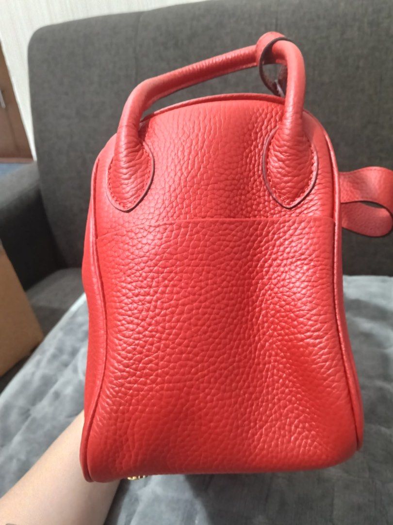 Red Leather Top Handle Bag with Gold Hardware 26cm (Category: Luxury Bags & Wallets) located in Cebu City. Submitted by latendacebubuys (Listing ID 1455553134, Image 3). Description: - Classic red leather handbag - Structured shape with secure turn-lock closure - Beautiful pebbled leather texture - Spacious interior lined in red - Elegant gold hardware details - Comfortable top handles for easy carrying.