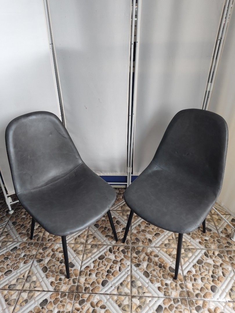 Set of 2 Dark Grey Dining Chairs (Category: Chairs) located in Manila. Submitted by rapidokasm88190 (Listing ID 1455522168, Image 1). Description: - Set of 2 dark grey chairs - Modern design with contoured seats for comfort - Sturdy black metal legs - Approximately 18 inches wide - Perfect for dining or as accent chairs - Pick up only.