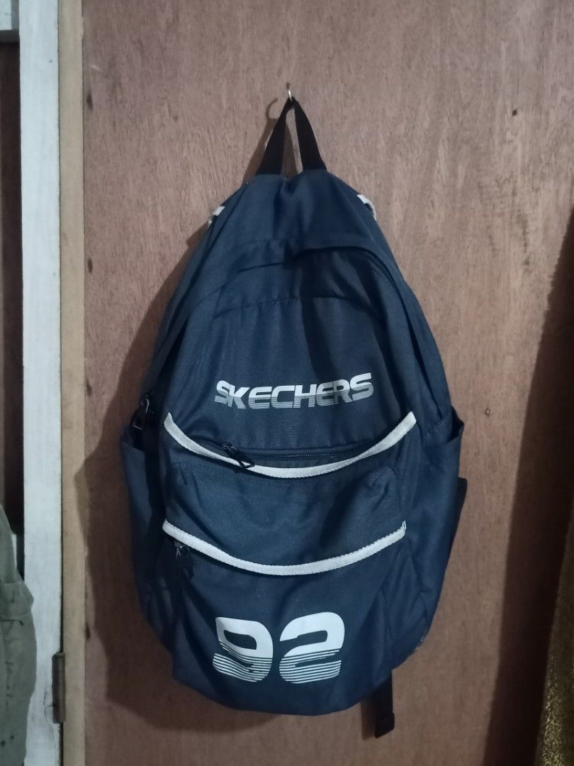 Skechers Backpack Navy Blue '92 Design (Category: Backpacks) located in Mangaldan. Submitted by harrapotter (Listing ID 1455593462, Image 1). Description: - Navy blue Skechers backpack - Features iconic '92 graphic on the front - Spacious main compartment - Convenient front pocket - Adjustable straps for a comfortable fit - Durable polyester material - Ideal for school, work, or everyday adventures.