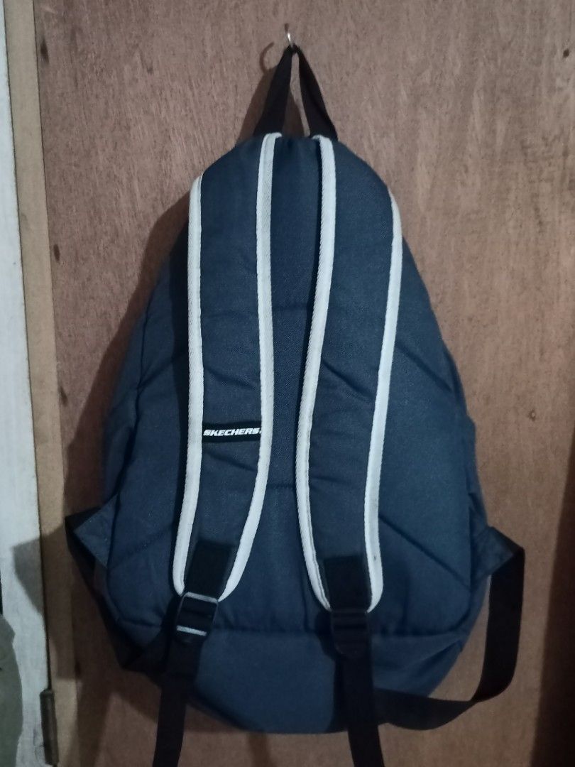 Skechers Backpack Navy Blue '92 Design (Category: Backpacks) located in Mangaldan. Submitted by harrapotter (Listing ID 1455593462, Image 2). Description: - Navy blue Skechers backpack - Features iconic '92 graphic on the front - Spacious main compartment - Convenient front pocket - Adjustable straps for a comfortable fit - Durable polyester material - Ideal for school, work, or everyday adventures.