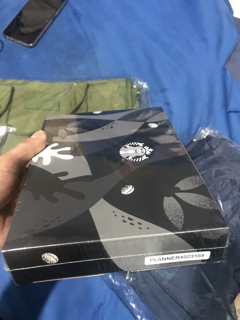 Starbucks Planner 2023 (Category: Stationery & School Supplies) located in Pasig City. Submitted by rorogrez78 (Listing ID 1455635566, Image 2). Description: - Brand new Starbucks Planner for 2023 - Sleek grey and black design with iconic Starbucks logo - Original packaging is still sealed - Ideal for organizing your year - Makes a perfect gift for Starbucks enthusiasts.