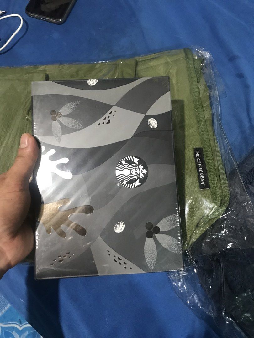 Starbucks Planner 2023 (Category: Stationery & School Supplies) located in Pasig City. Submitted by rorogrez78 (Listing ID 1455635566, Image 1). Description: - Brand new Starbucks Planner for 2023 - Sleek grey and black design with iconic Starbucks logo - Original packaging is still sealed - Ideal for organizing your year - Makes a perfect gift for Starbucks enthusiasts.