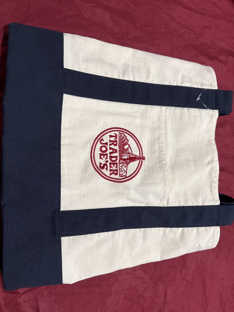 Trader Joe's Reusable Tote Bag (Category: Tote Bags) located in Manila. Submitted by pickstuff (Listing ID 1455555582, Image 1). Description: - Classic Trader Joe's tote bag - Original - Sturdy canvas material - Iconic embroidered Trader Joe's logo - Ideal for groceries or everyday use - Easy to clean and durable.