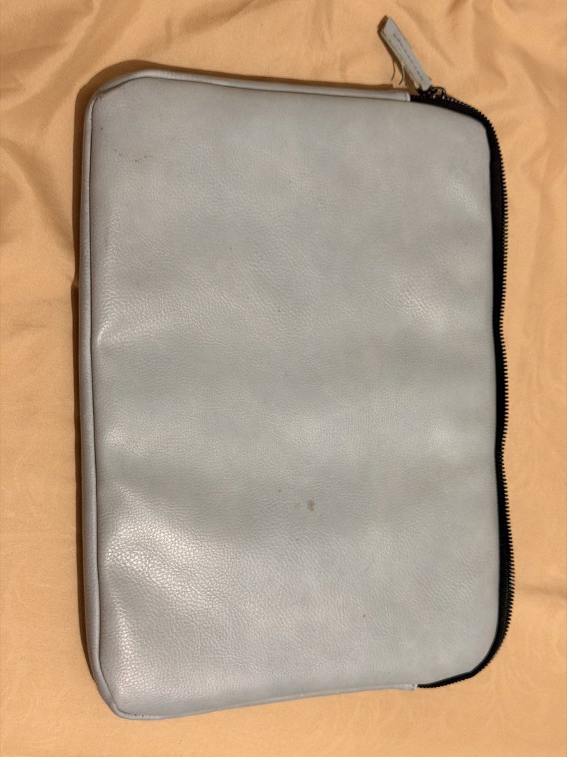 Typo Light blue Laptop Sleeve (Category: Laptop Bags & Sleeves) located in Manila. Submitted by starapple24_ (Listing ID 1455619059, Image 2). Description: - Grey laptop sleeve from Anything But Ordinary - Soft black interior lining - Zipper closure - Small stain on the front (visible in the last photo).