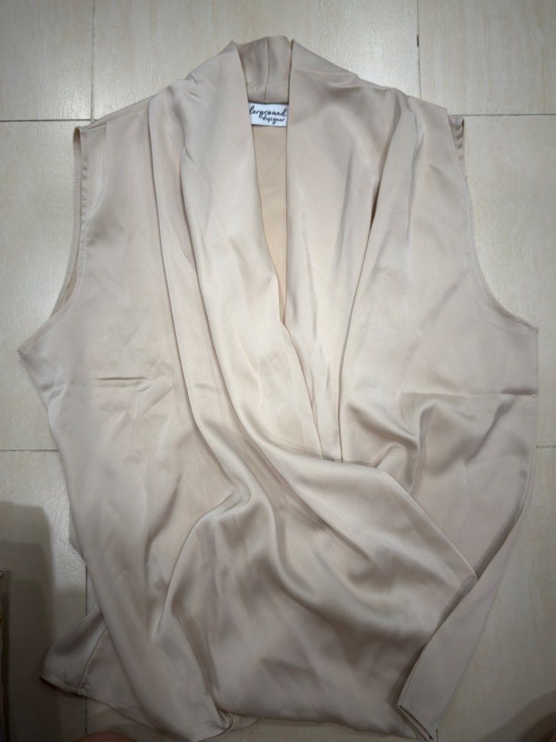 Underground Designer Sleeveless Drape Top Beige (Category: Sleeveless) located in Manila. Submitted by act92 (Listing ID 1455510594, Image 1). Description: - Beige sleeveless top from Playground Designer - Features a flattering wrap-around style - Made with a smooth, silky-looking fabric - Versatile for dressing up or down - Creates a chic and elegant look.