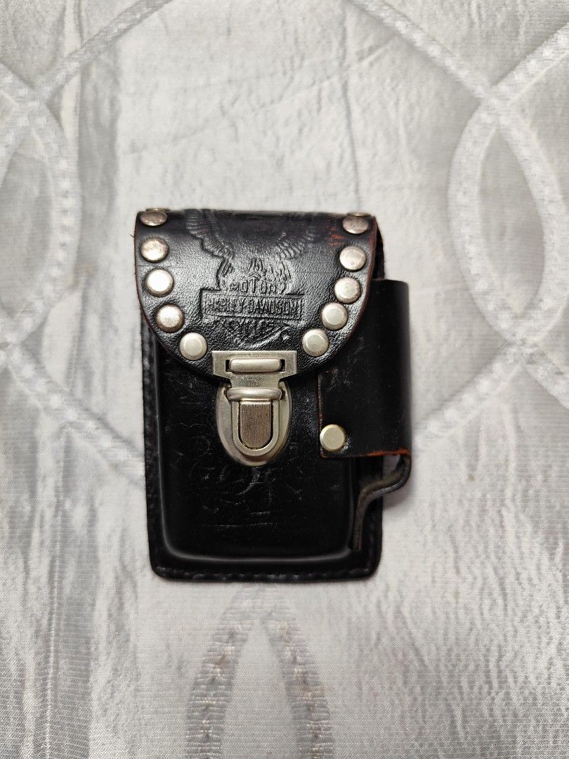 vintage Harley Davidson cigarette and lighter holder (Category: Wallets & Card Holders) located in Santa Rosa. Submitted by ahroncatpad (Listing ID 1455588981, Image 2). Description: vintage collectible Harley Davidson cigarette and lighter holder can he attached on your belt or body bag thick genuine leather material with studs leather paint faded on some parts leather in good condition,no tear,no bakbak Made In USA.