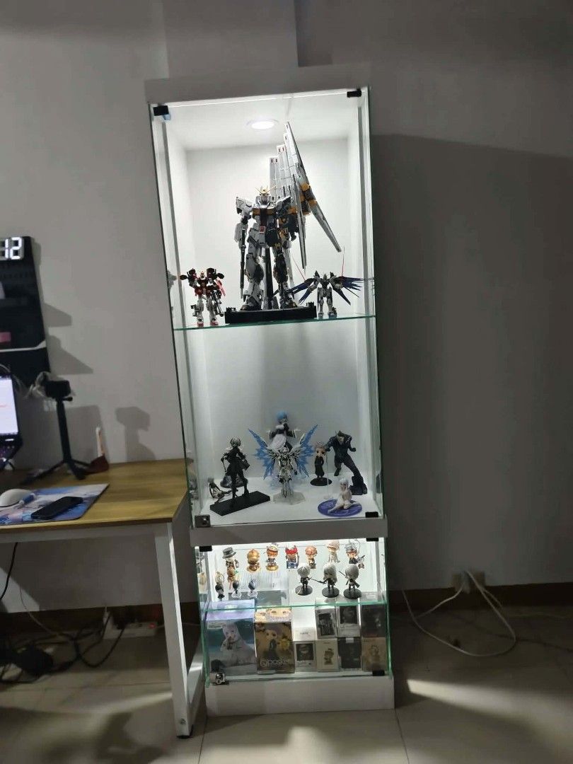 White Glass Display Cabinet with LED Lighting (Category: Shelves, Cabinets & Racks) located in Manila. Submitted by ronav25916562 (Listing ID 1455592810, Image 1). Description: - Tall display cabinet (approx. 180cm) - Multiple glass shelves for display - Built-in LED lighting at the top - Clean, modern aesthetic - Ideal for showcasing collectibles, figures, or decor - Suitable for any room.
