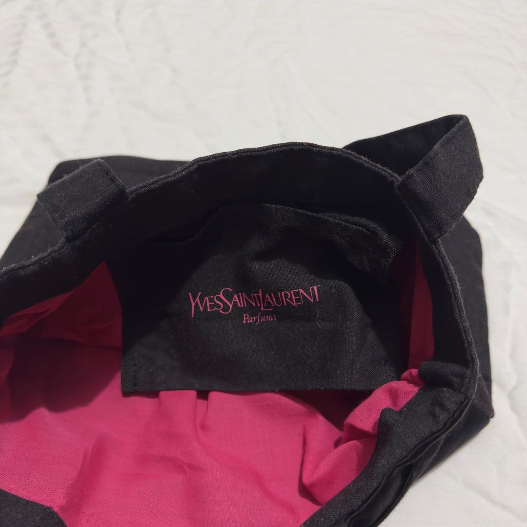 YSL PARFUMS TOTE (Category: Luxury Bags & Wallets) located in Pasig City. Submitted by jaaard (Listing ID 1455660663, Image 2). Description: - Cute YSL tote bag - Dark grey canvas with black satin ribbon detail - Bright pink fabric lining - Ideal for everyday use or travel - Shows some signs of wear, but plenty of life left.